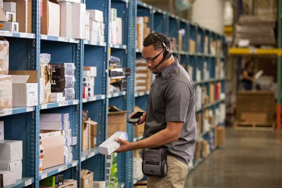 Worker taking stock in a warehouse