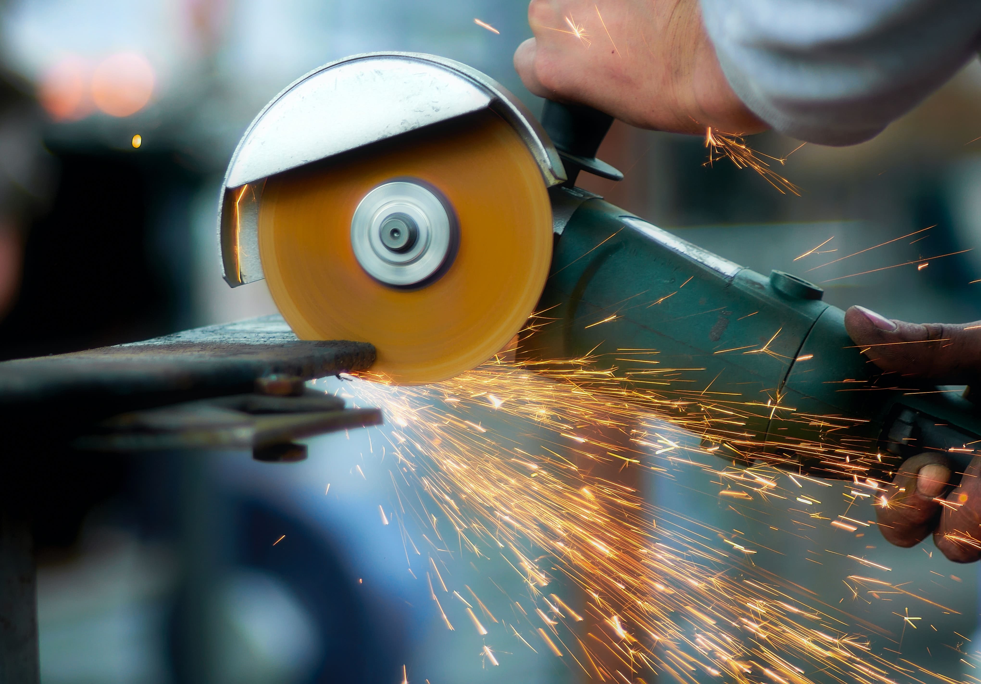 Focused worker standing in noisy workshop